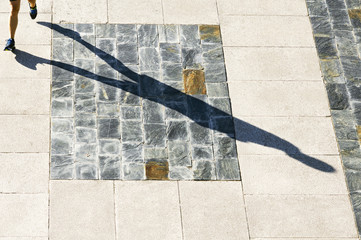 runner man athlete with shadow  in the seafront promenade in cit