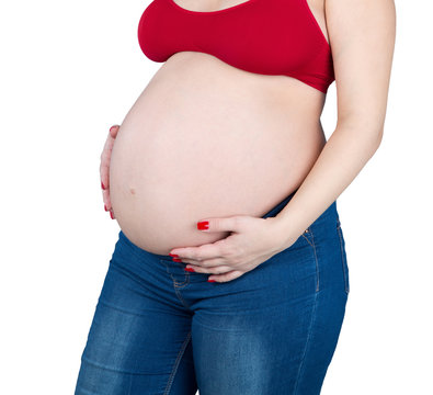 Изображение беременной женщины, касаясь руками живота.