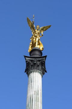 Bogenhausen, Munich, Germany: Steeple of the Peace Column with golden Angel of Peace (Friedensengel) in the center of the capital of Bavaria