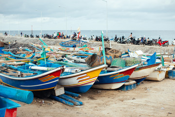 Naklejka na ściany i meble Colorful fishing boats anchored at a Beach in Bali Island, Indon