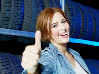 Female customer shows thumb up for tire storing