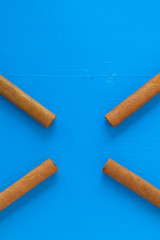 Detail of luxury Cuban cigars on the blue table