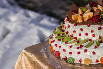 two-tiered cake with fruits and chocolate