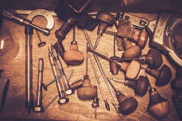 Different goldsmiths tools on the goldsmith workplace.