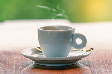 Hot espresso, Black coffee in white cup on wooden table.