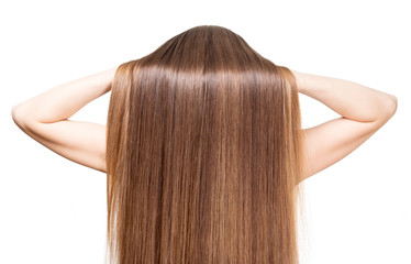 She raises her hands smooth shiny brown hair isolated.