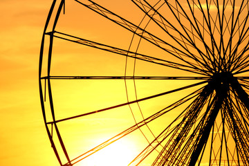 Abstract Background, ferris metal-wheel against sky with sunset.