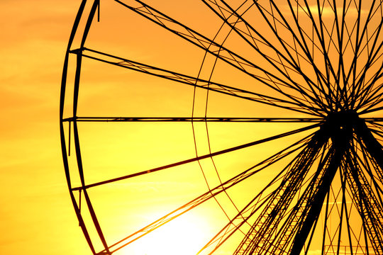 Abstract Background, ferris metal-wheel against sky with sunset.