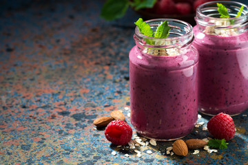 berry smoothie in a bottle on a dark background