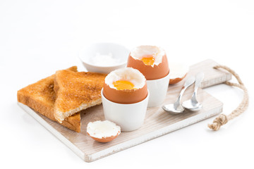 boiled eggs and crispy toasts on a wooden board