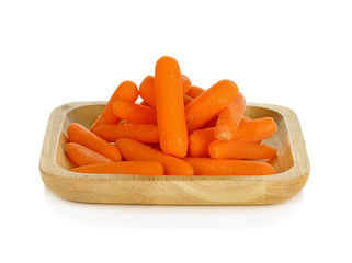 babay carrots in wooden plate on white background