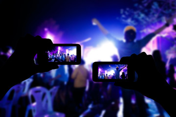 Fototapeta na wymiar Take photo crowd in front of concert stage blurred