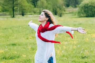 Young woman with outstretched hands enjoying outdoors
