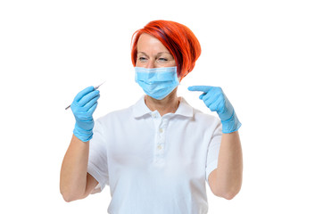 Female dentist wearing face mask and rubber gloves