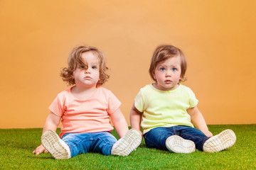 Happy funny girl twins sisters playing and laughing