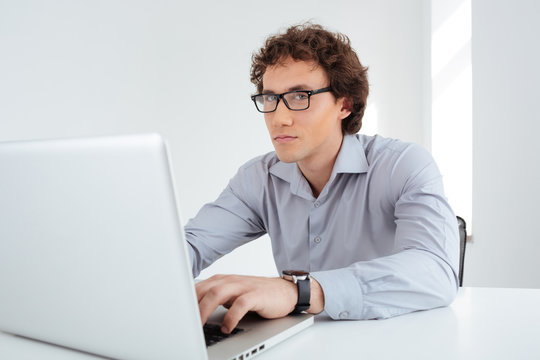 Businessman working on laptop computer in office