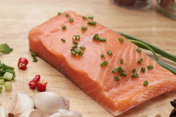 fresh raw salmon fillet on wood background.