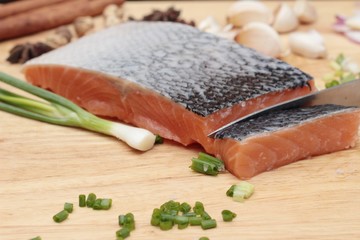 fresh raw salmon fillet on wood background.