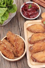 Korean fried chicken is delicious on wood background.