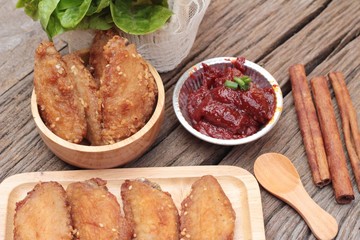 Korean fried chicken is delicious on wood background.