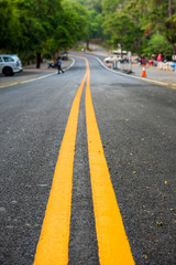 Asphalt road, yellow line on the new road