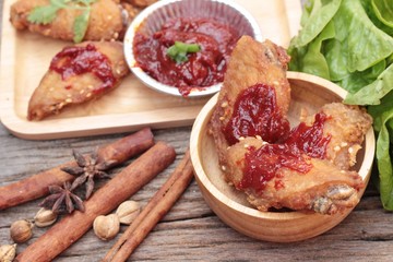 Korean fried chicken is delicious on wood background.