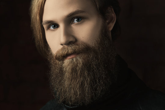 portrait of the brutal young man with a beard in studio against