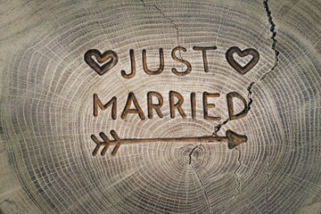 Woodcarving. Newlyweds, Just married, inscription on the wedding