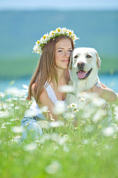 Beautiful woman with labrador on nature 