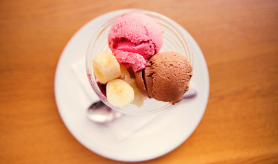 strawberry and chocolate ice cream with banana. View from above