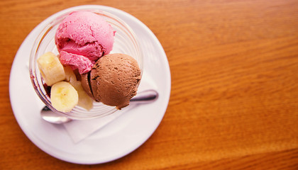 strawberry and chocolate ice cream with banana. View from above