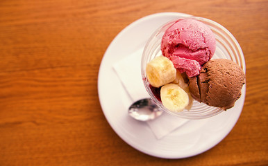 strawberry and chocolate ice cream with banana. View from above