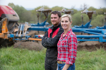 Young farmers with new tractor - 111419203
