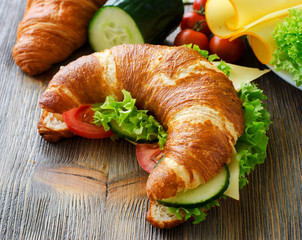 Croissant sandwich with cheese and vegetables, healthy picnic sn