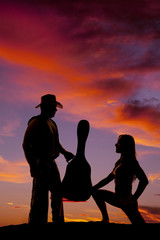 silhouette of  woman on one knee look side at cowboy
