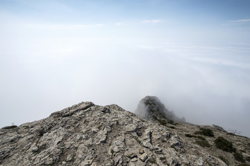 View from the rocky top of the mountain above the clouds. Crimea, Sudak