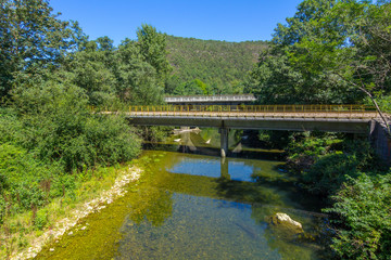 Fototapeta na wymiar Small railway bridge over a river