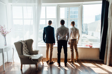 three Businessman looking out the window