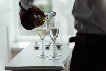 men pour champagne into glasses