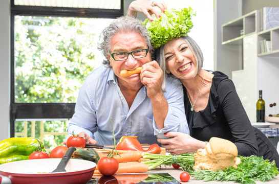 Senior Couple Having Fun In Kitchen With Healthy Food - Retired Poeple Cooking Together Vegetarian Gourmet Plate At Home