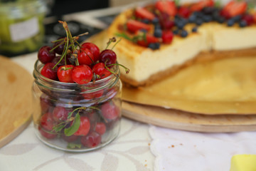 Fresh cherries in bowl on table