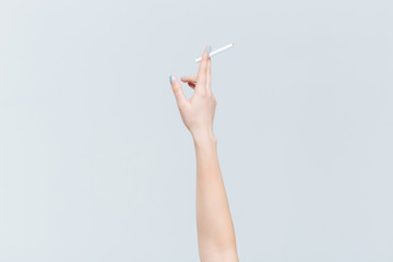 Female hand holding cigarette © Drobot Dean