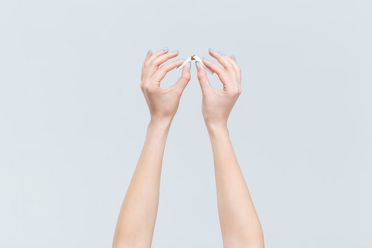 Female hands broken cigarette
