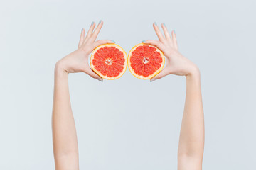 Female hands holding grapefruits