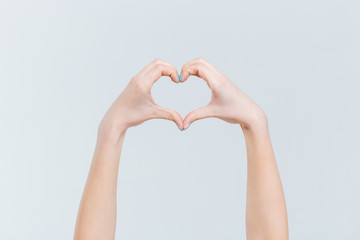 Obraz premium Female hands showing heart gesture with fingers