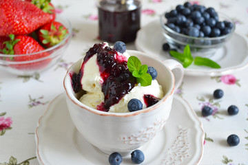 Vanilla ice cream with blueberry jam in a cup