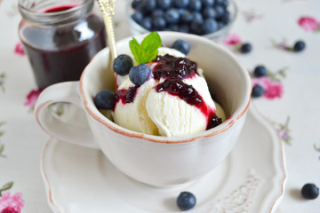 Vanilla ice cream with blueberry jam in a cup