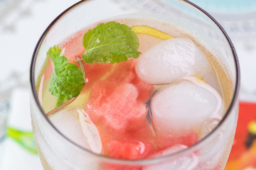 Glass of cold fruit and berries, mint infused water.