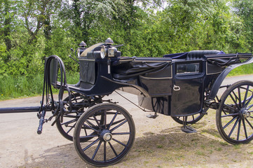 Fototapeta na wymiar Black carriage for horse riding.