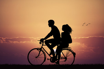 couple on bicycle at sunset